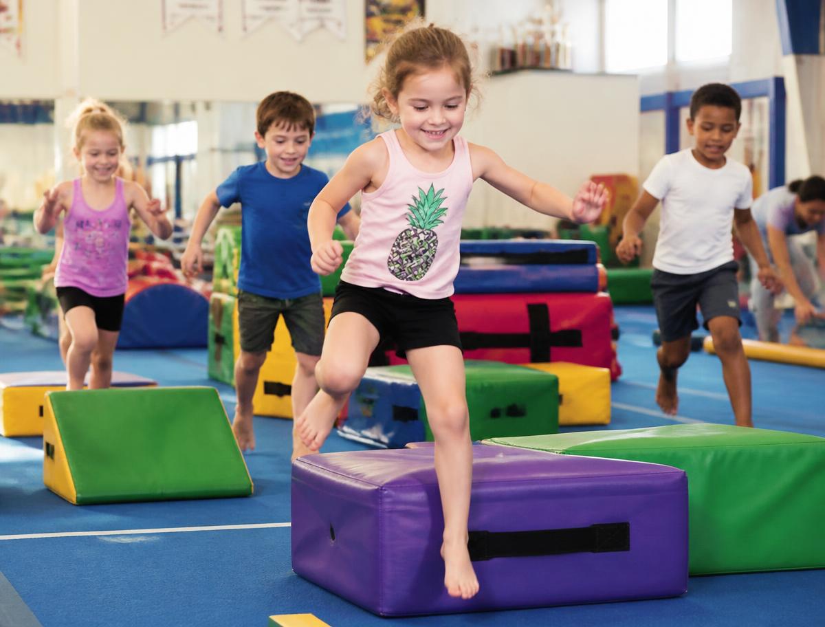 Children running an obstacle course in the gym